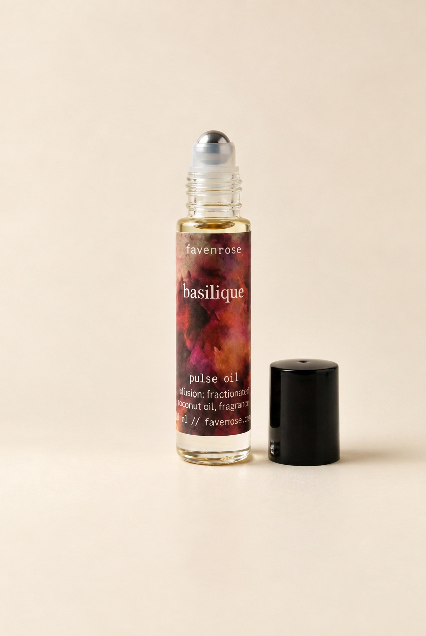Basilique Pulse Oil with the black lid beside the bottle and stainless steel roller exposed