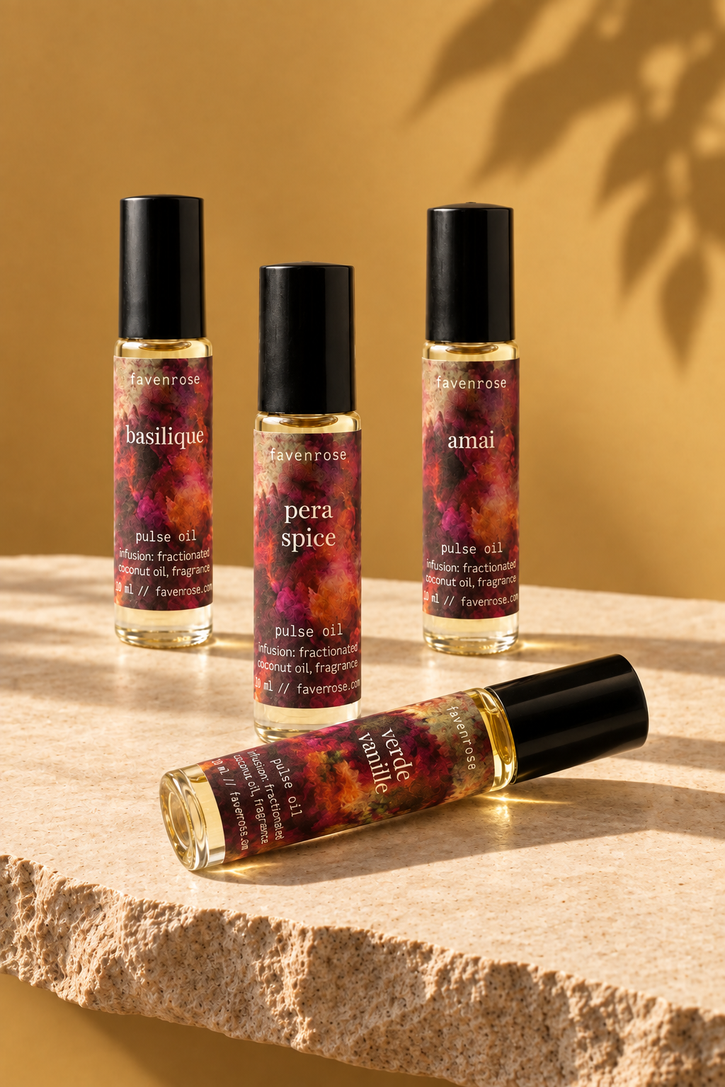 Four Favenrose Pulse Oils on light raw-edge stone against a yellow wall