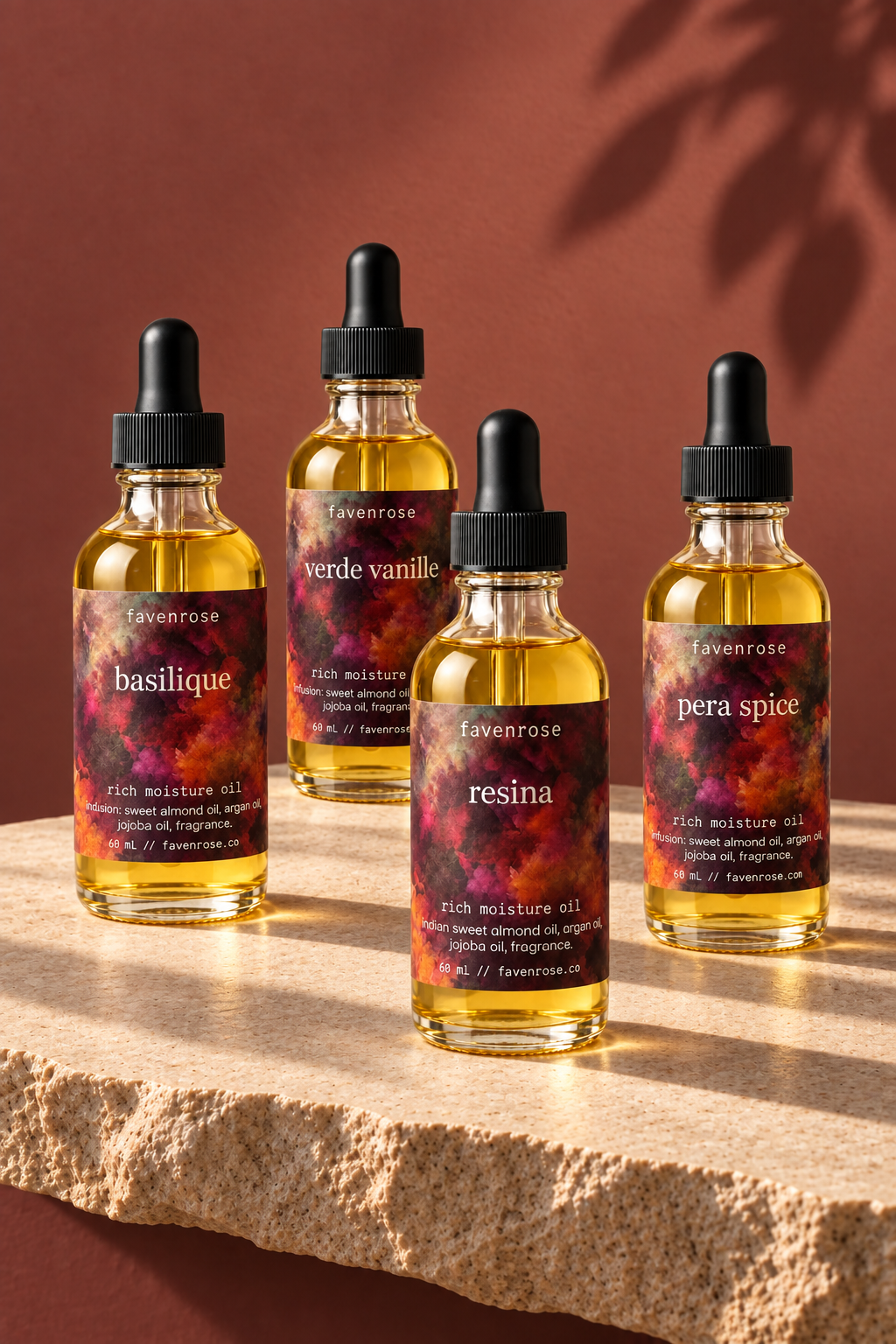 Four Favenrose Rich Moisture Oils on pale stone against a terracotta wall