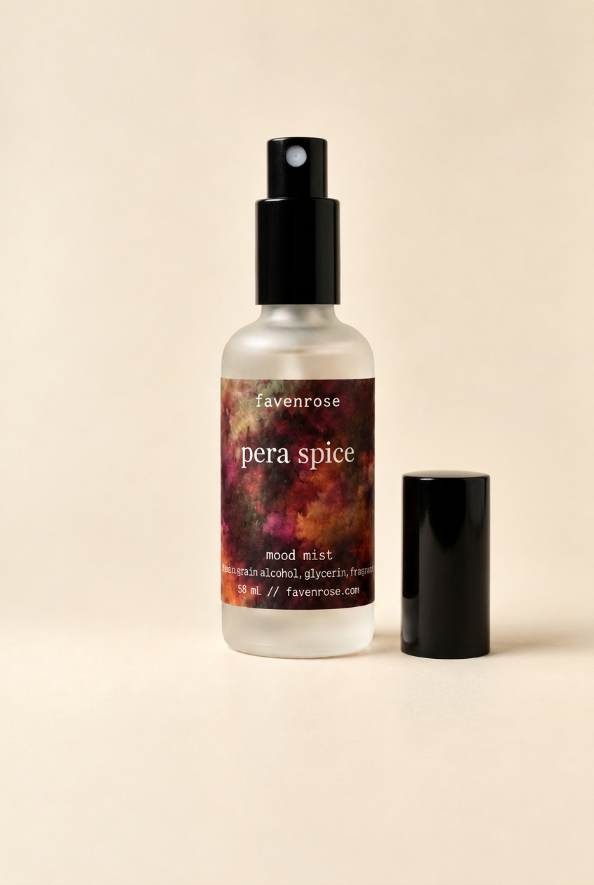 Pera Spice Mood Mist on a warm ivory background with its black lid removed and placed beside the bottle
